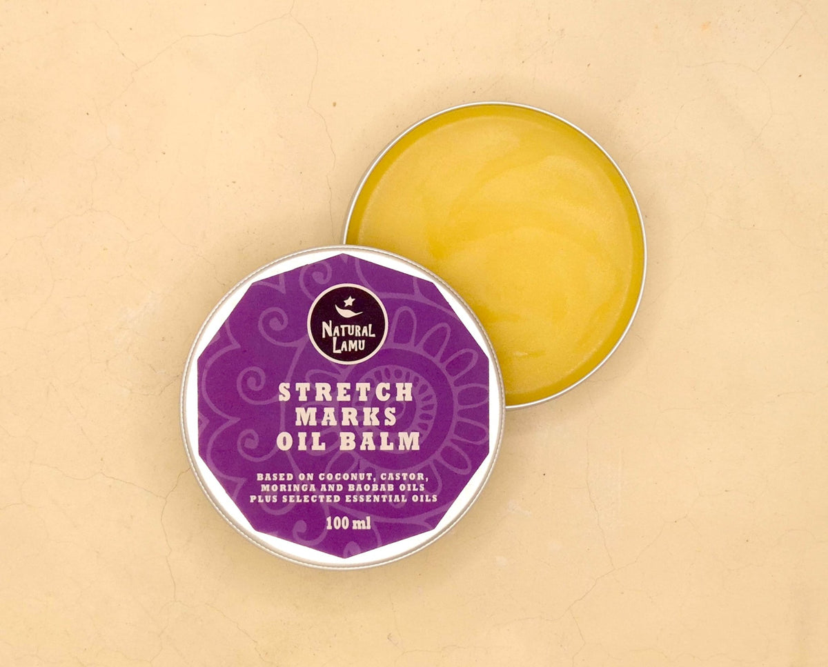 Tin of Natural Lamu Stretch Marks Oil Balm and scoop of balm on wooden surface
